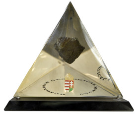 Stone suspended inside a crystal pyramid, received on behalf of the Hungarian Geological Survey
